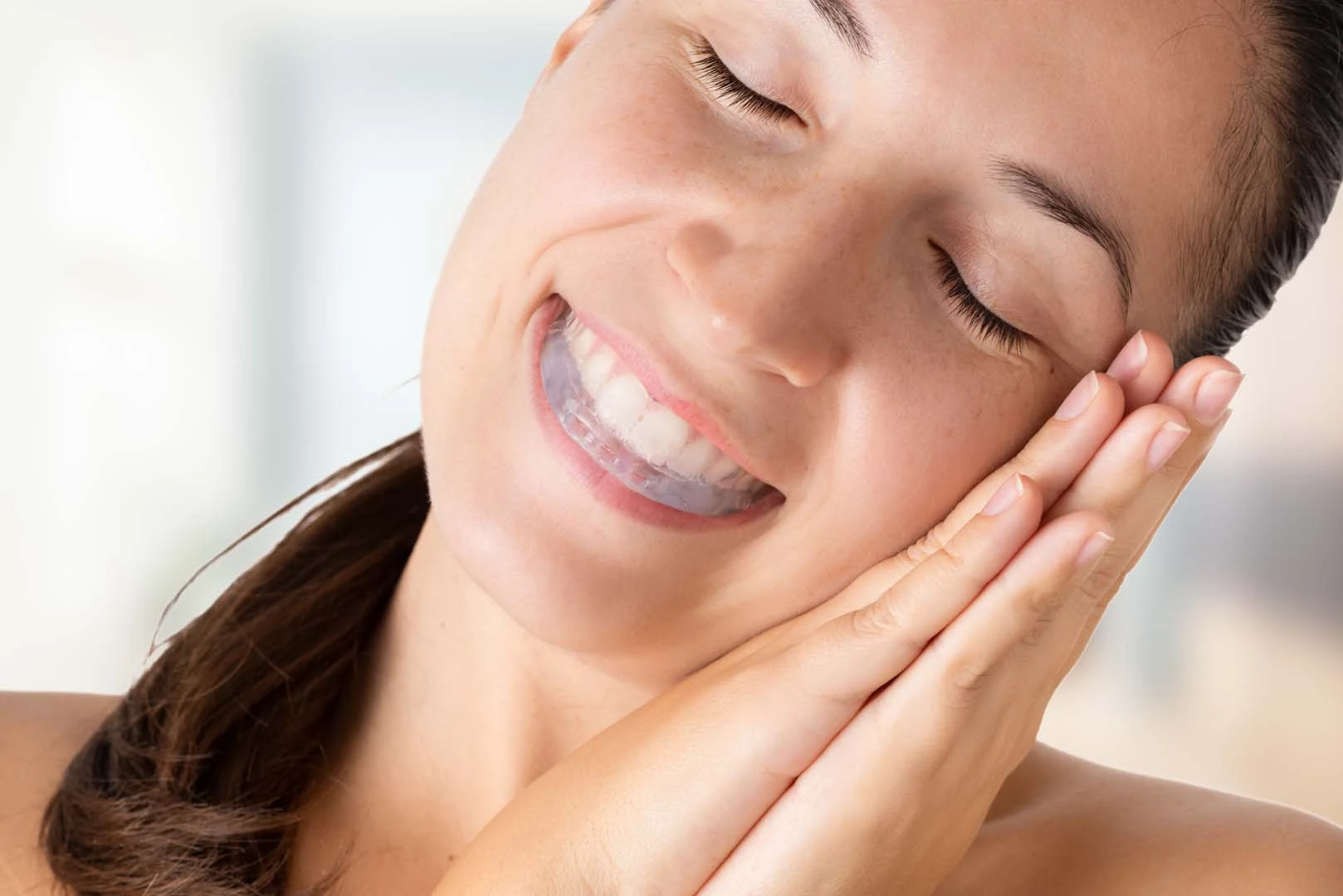 Woman wearing a dental guard while sleeping